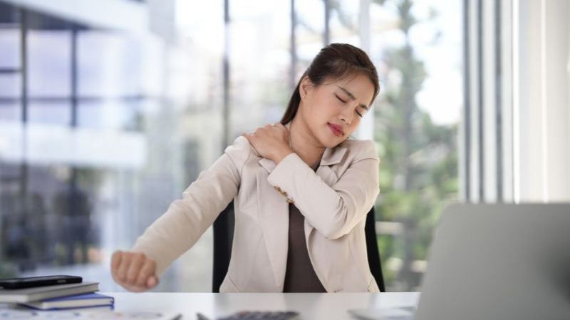 Office worker slouching at a desk showing poor sitting posture