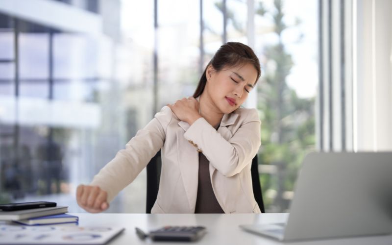 Office worker slouching at a desk showing poor sitting posture
